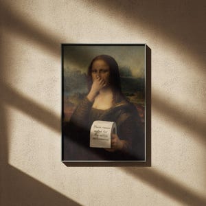 May include: Framed print of the Mona Lisa holding a roll of toilet paper with the text "Please remain seated for the entire performance." The artwork is set against a neutral wall with shadows.