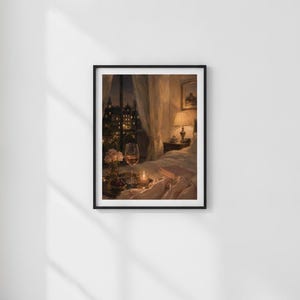 May include: A framed wall art print depicting a cozy bedroom scene at night. The image features a bed with rumpled white linens, a glass of wine, a small vase of flowers, and a glowing lamp on a nightstand, with a city view through a window.