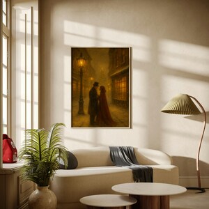 May include: A framed print showing a romantic winter scene with a couple embracing on a snowy street, lit by a gas lamp. The artwork is displayed above a cream sofa, with a round coffee table and a floor lamp.