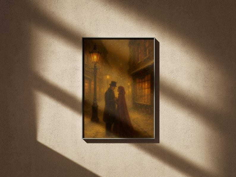 May include: Framed artwork showing a couple embracing in a snowy street at night. A gas lamp lights the scene, with buildings lining the street. The woman wears a red cloak, and the man wears a hat and coat. The artwork has a vintage, romantic feel.