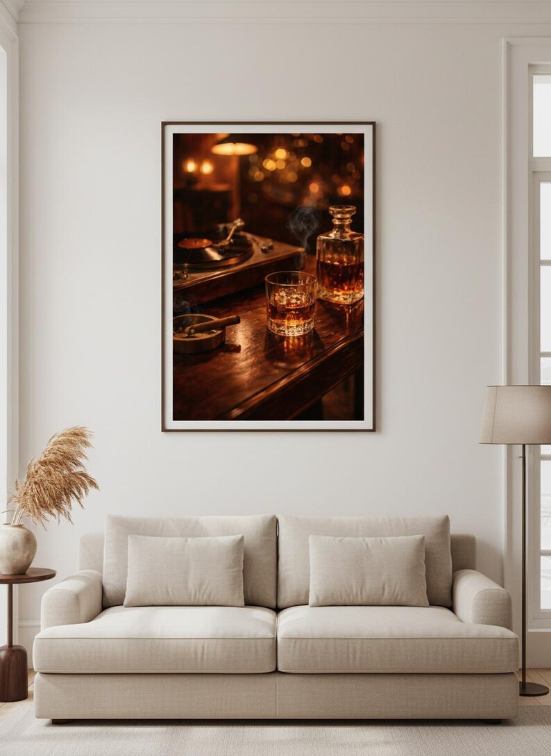 May include: A framed print featuring a still life with a vintage record player, a glass of whiskey with ice, a decanter, and a lit cigar in an ashtray. The scene is set on a dark wooden surface, with soft lighting.