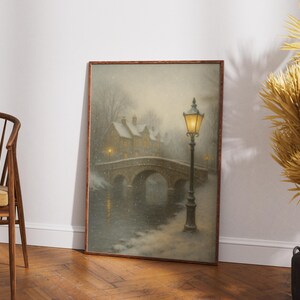 May include: Framed art print depicting a winter scene with a stone bridge, snow-covered buildings, and a glowing street lamp. The artwork has a vintage, painterly style, with soft colors and a serene atmosphere. The bridge arches over a body of water.
