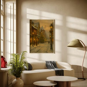 May include: A framed painting depicts a snowy street scene with buildings, a Christmas tree, and figures. The artwork hangs above a cream-colored sofa with a gray throw, two round coffee tables, a floor lamp, and a potted plant.