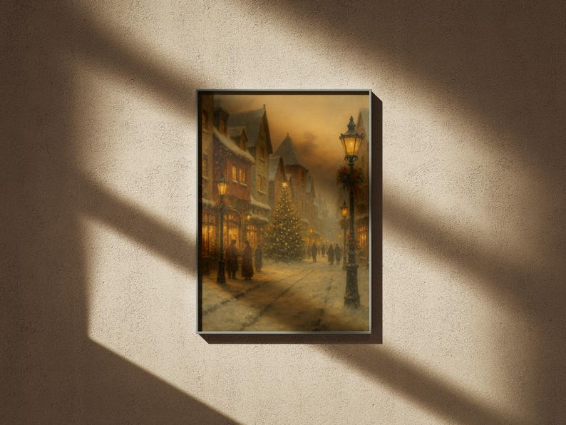 May include: Framed print of a winter scene depicting a snow-covered street lined with buildings and lit by street lamps. A Christmas tree stands in the center, with figures of people walking along the street. The artwork has a warm, inviting color palette.