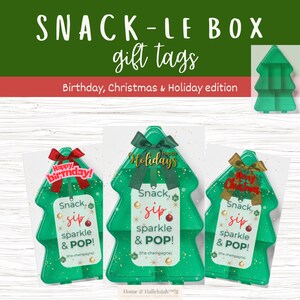 May include: Green tree-shaped gift tags with bows and the words "Happy Birthday", "Happy Holidays", and "Merry Christmas". Each tag has the words "Snack, sip, sparkle & POP!" and "the champagne".