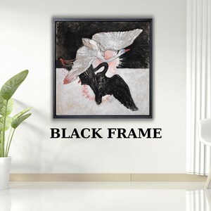 Puede incluir: Impresión artística abstracta en un marco negro. La obra representa dos cisnes, uno blanco y otro negro, en vuelo. El fondo es una mezcla de tonos negros, blancos y rosas. El texto "BLACK FRAME" está debajo.