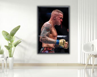 May include: A framed print depicting a mixed martial arts fighter in a UFC match. The fighter is shirtless, with tattoos on his arms and a bloody nose. He wears gold and blue gloves. The background is dark, with the word "HOSPITAL" visible.
