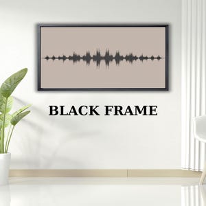 May include: A framed artwork featuring a sound wave design in dark gray against a light tan background. The frame is black, and the text "BLACK FRAME" is displayed below the artwork. The piece is displayed on a white wall.