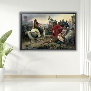 May include: A framed historical painting showing a scene with figures in classical attire. A man on horseback is the focal point, surrounded by a crowd. The artwork features a muted colour palette with a dark frame, suitable for home decor.