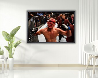 May include: A framed image of a mixed martial arts fighter in a UFC match. The fighter is shirtless, with blood on his face and chest. He is wearing black gloves with the UFC logo. The background shows the cage and spectators.