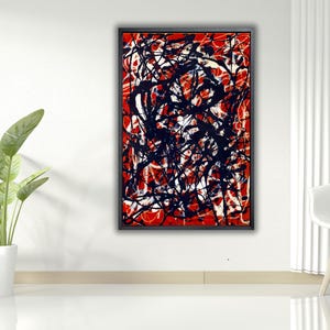 Puede incluir: Pintura abstracta enmarcada en negro. La obra presenta un fondo rojo con salpicaduras y líneas de pintura negra y blanca. La pintura se exhibe en una pared blanca.