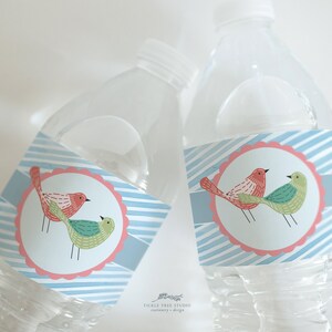 May include: Clear plastic water bottles with labels featuring a pair of cartoon birds in red and green. The labels have a light blue background with white stripes and a pink scalloped border. The text "Tickle Tree Studio" is at the bottom.