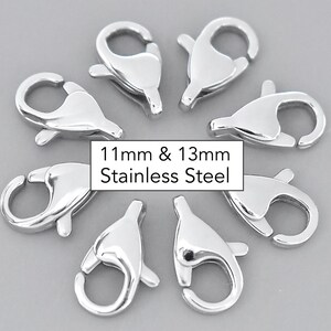 May include: Eight silver-toned metal lobster clasps, 11mm and 13mm in size, for jewelry making.