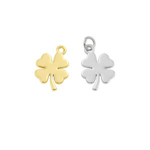 May include: Two four-leaf clover charms, one gold and one silver, for jewelry making.