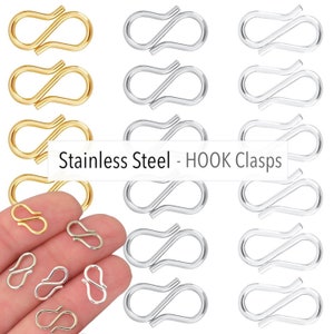 May include: A set of 18 stainless steel hook clasps in gold, silver, and a mix of both. The clasps are in the shape of an 'S' and are used for jewelry making.