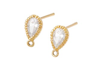 May include: A pair of gold teardrop earrings with clear cubic zirconia stones.