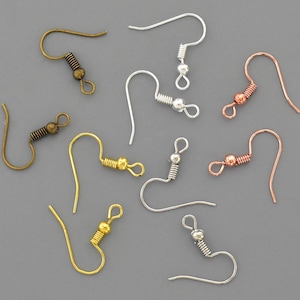 May include: Assortment of earring hooks in various finishes, including gold, silver, and copper. The hooks are all the same size and shape, with a small loop at the top and a spring-loaded clasp at the bottom.