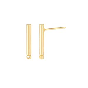 May include: A pair of gold-toned bar earrings with a smooth, cylindrical design. The earrings have a small ball at the bottom.