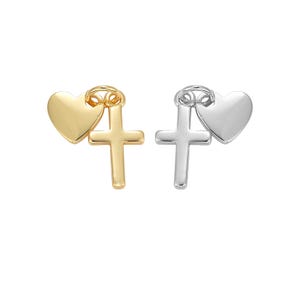 May include: Two charms, one gold and one silver, each featuring a heart and a cross. The gold charm has a heart on top of a cross, while the silver charm has a cross on top of a heart.