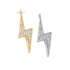 May include: Two lightning bolt charms, one gold-toned and one silver-toned, each encrusted with small, clear crystals. The charms have a loop at the top for hanging and are set against a white background. These are suitable for jewelry making.