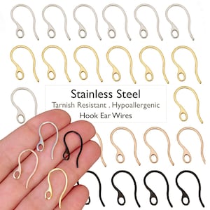 May include: A collection of stainless steel hook ear wires in silver, gold, rose gold, and black finishes. The text Stainless Steel Tarnish Resistant Hypoallergenic Hook Ear Wires is centered in the image, surrounded by various metal earring hooks.