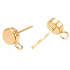 May include: Gold-toned earring findings with a round disc and a small loop. The findings are designed for attaching to earrings.