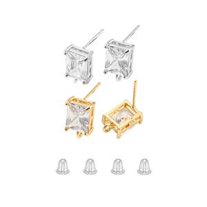 May include: Four pairs of earring findings with clear cubic zirconia stones. Two pairs are silver-toned and two pairs are gold-toned. Each pair includes a pair of earring backs.