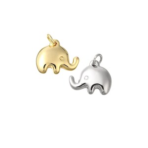 May include: Two elephant charms, one gold and one silver, with a simple design. The charms are perfect for adding a touch of whimsy to jewelry.
