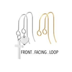 May include: Silver and gold-colored earring hooks. One pair of silver earrings features a cross and heart charm. The other pair is gold-colored. The text "FRONT. FACING. LOOP" is printed below the earrings.