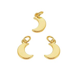 May include: Three gold crescent moon charms with jump rings. The charms are perfect for adding a touch of whimsy to jewelry projects.