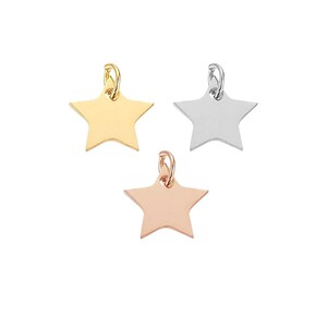 May include: Three star-shaped charms in gold, silver, and rose gold. Each charm has a loop at the top for attaching to a necklace or bracelet.