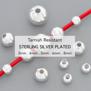 May include: Tarnish resistant sterling silver plated round beads in various sizes: 3mm, 4mm, 5mm, 6mm, and 8mm. The beads are shown on a red cord.