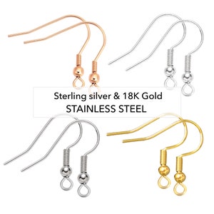 May include: An assortment of earring hooks in rose gold, silver, and gold tones. The image includes the text "Sterling silver & 18K Gold STAINLESS STEEL". The hooks have a coiled spring and a small ball detail.