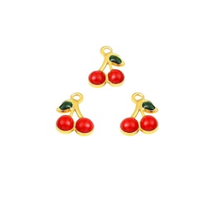 May include: Three gold-tone cherry charms with red enamel cherries and green enamel leaves.