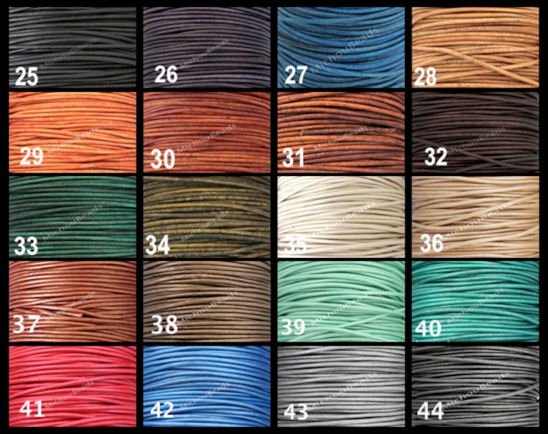 May include: A selection of leather cord spools in a range of colours, such as black, blue, brown, green, and red. Each spool is numbered from 25 to 44. The tightly wound cords display their texture and colour variations.