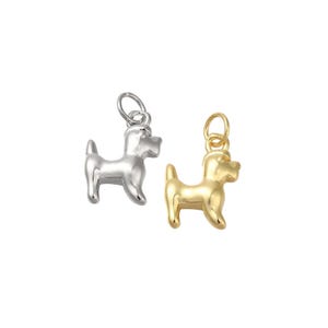 May include: Two dog charms, one silver and one gold, in the shape of a small dog with a curled tail.