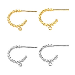 May include: Four pairs of hoop earrings with a beaded design. Two pairs are gold and two pairs are silver.