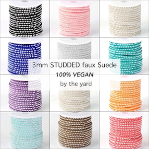 May include: A grid of spools of 3mm studded faux suede ribbon in various colors, including black, pink, beige, blue, silver, teal, purple, tan, orange, light blue, brown, and coral. The text "100% VEGAN" and "by the yard" are also visible.