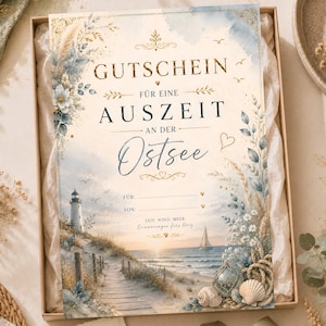 May include: A rectangular gift voucher featuring a coastal scene with a lighthouse, a sailboat, and a wooden path. The text reads GUTSCHEIN FÜR EINE AUSZEIT AN DER OSTSEE, FÜR, VON, ZEIT. WIND. MEER. Erinnerungen fürs Herz, decorated with gold and blue floral accents.