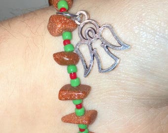 Pulsera con dije de ángel navideño