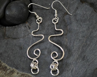 Long sterling silver dangle earrings.  Hand formed.  Tendrils