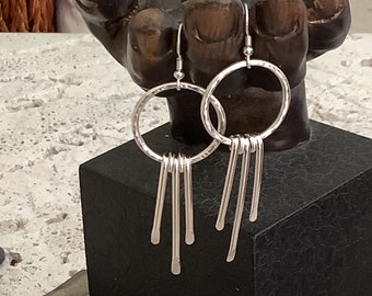 Long sterling silver hoop earrings with dangles.