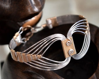 Egyptian wire wrapped Bracelet with a Twist.  Sterling Silver and 14K Gold filled.