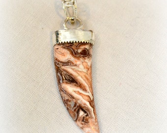 Rosetta stone tooth pendant.  Capped in Sterling silver.  "zig zag"