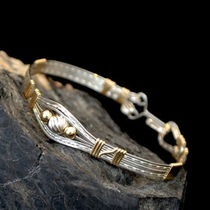 RuLaLa    Sterling silver and 14K gold filled wire wrapped bracelet.