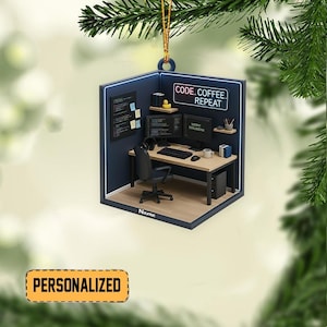 May include: A personalized Christmas ornament shaped like a computer programmer's workspace. The ornament features a desk with dual monitors, a keyboard, and a coffee mug. The text "CODE. COFFEE. REPEAT" is displayed above the desk.