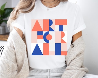 May include: A white short-sleeved t-shirt featuring a graphic design with the text ART FOR ALL. The text is composed of geometric shapes in shades of coral, navy blue, and light pink, arranged in a grid pattern on the center of the chest.