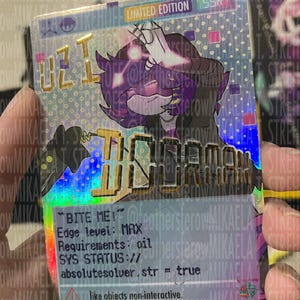 May include: A rectangular holographic trading card featuring a purple-haired character with the text UZI and BITE ME! printed on the front. The card includes technical specifications like Edge level: MAX, Requirements: oil, and SYS STATUS: // absolutesolver.str = true.