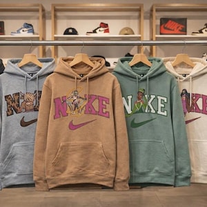 May include: A set of three ceramic mugs with a speckled, matte finish. The mugs are in shades of cream, light gray, and dark gray. Each mug has a simple, minimalist design and a rounded handle.