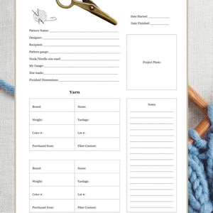 May include: A white knitting project planner with sections for pattern details, yarn information, and notes. A pair of antique brass scissors and a blue yarn are also visible. The planner includes spaces for project photos and dimensions.